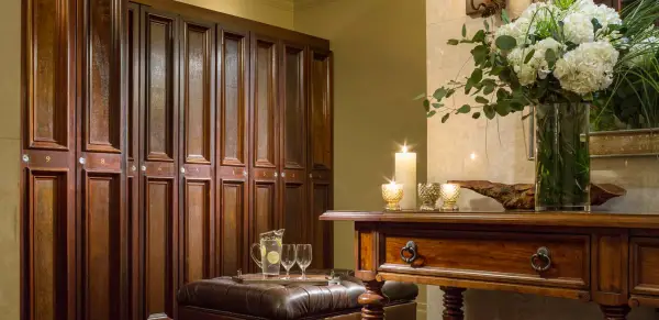 Dark wooden lockers and candles with leather seats appoint the men's lockerroom