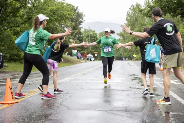 Runner gives high fives while racing