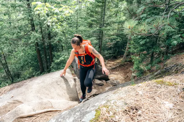 Hiker walks up rocky section of trail