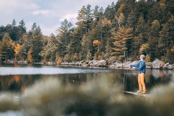 Fishing at a scenic pond in the fall