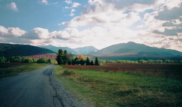 A view of mountains in the fall from a road
