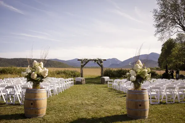 The wedding site with rustic alter adorned with hydrangeas and hay bales