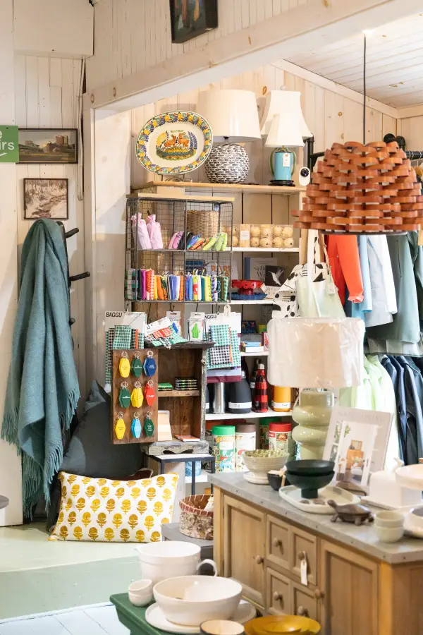 A view of the room showing the whole space with key chains, lamps, bowls, decor and blankets