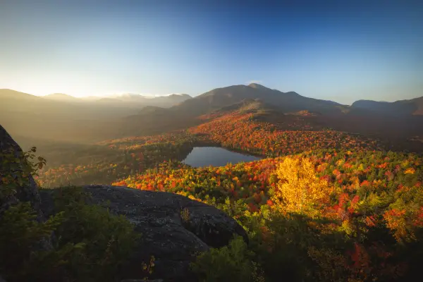 A small pond amongst tall mountains in the fall