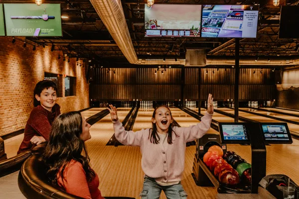A young family is very excited to bowl.  Photo Credit to A. Kelly.