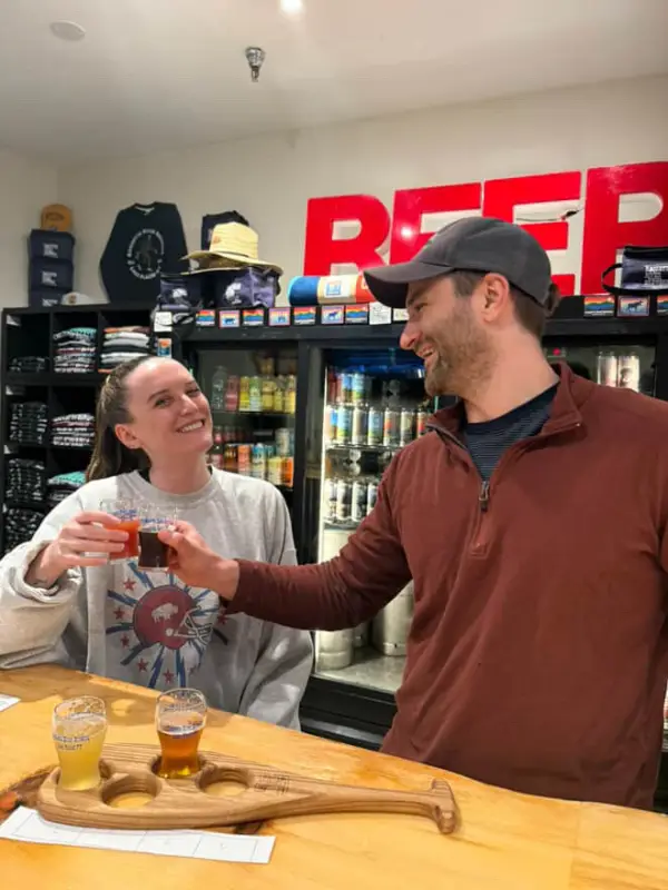 Two patrons enjoying a tasting flight of beers