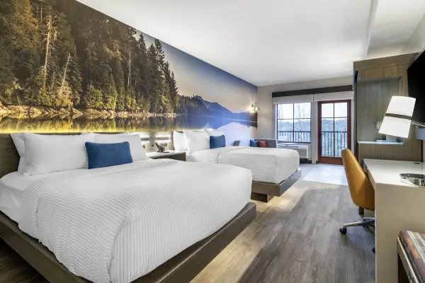 Large rooms with beautiful mountain and lake mural on the accent wall with fun pops of color and a modern feel.