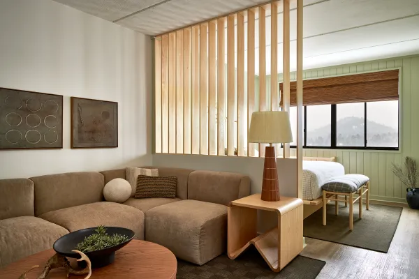 Sitting room space separated from the bed by signature slat wall.