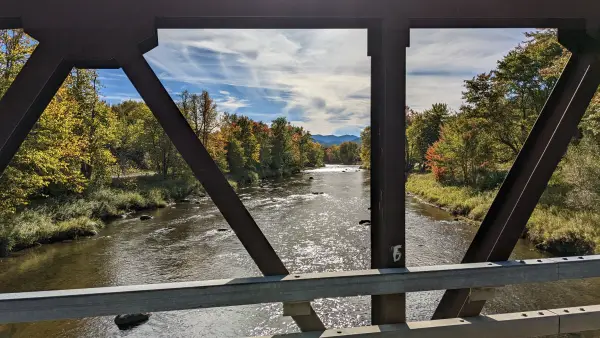 View through a metal bridge over a river