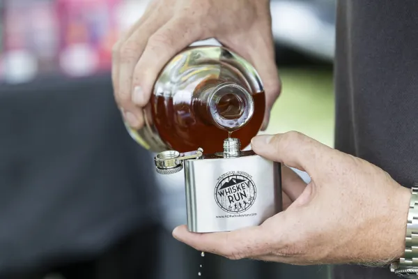 Whiskey pouring into flask