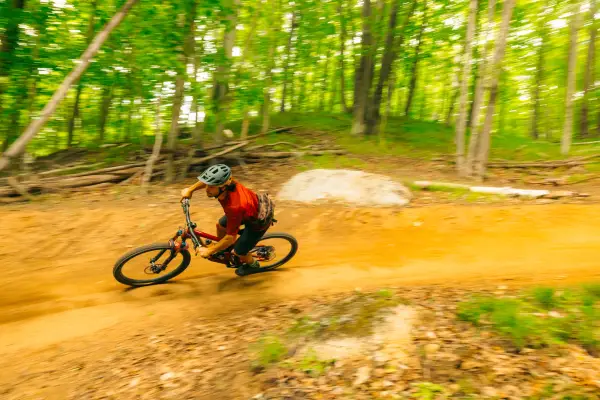 A mountain biker going around a berm