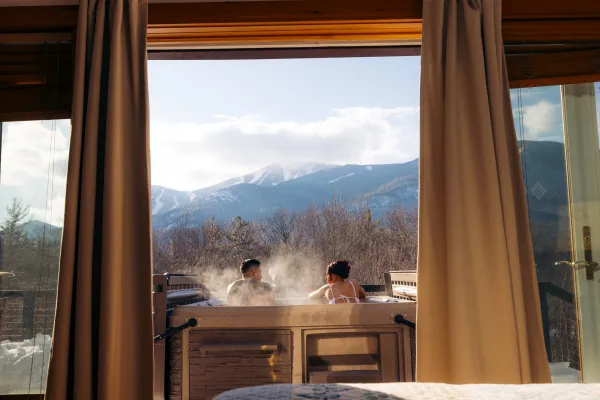 A man and woman relax in a hot tub. 