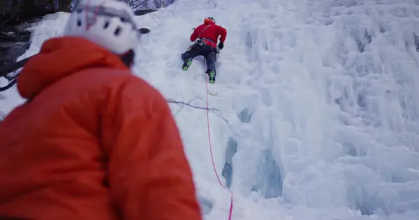 A person belaying an ice climber