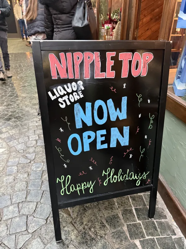 Grand opening sign at Nippletop Liquors