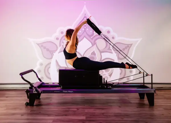 a woman uses an exercise machine