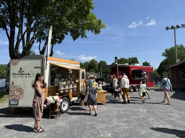 A traveling flower stand called the Mossbrook Bloom Bar is designed to showcase all the beautiful flowers grown on the farm with shelves modified to hold galvanized water buckets filled with peonies