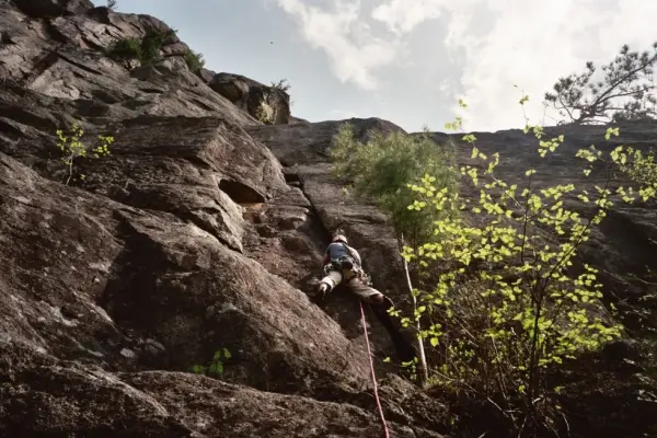 Someone climbing up a rock climbing roiute