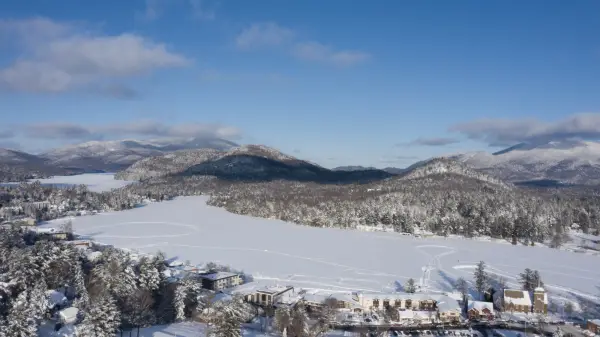 A frozen lake surrounding by a small town