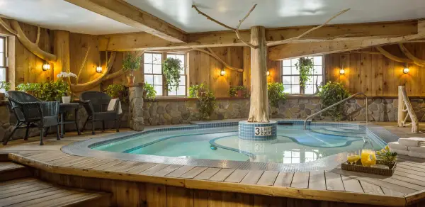 A warm indoor jacuzzi awaits you with lush foliage surrounding
