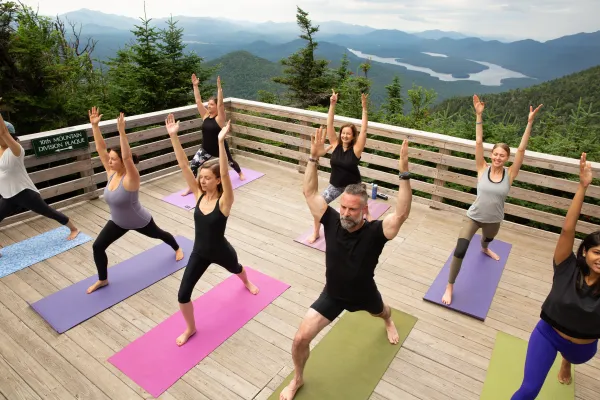 Mountain top yoga on the Little Whiteface observation deck looking over Lake Placid