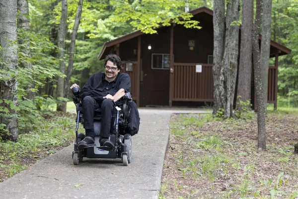 A man in a wheelchair in a campground