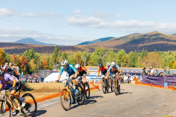 Competitors on course, among a scenic backdrop of fall foliage on the Adirondack Mountains. 