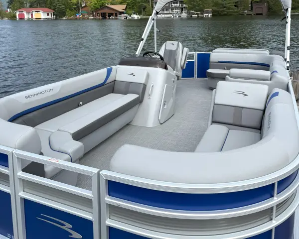 A blue and white pontoon boat from the front