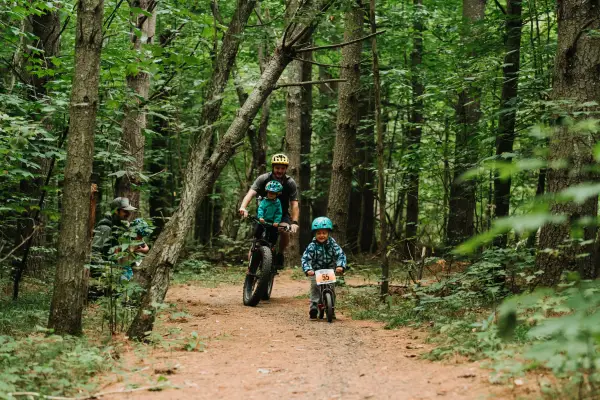 A father and his two kids mountain biking