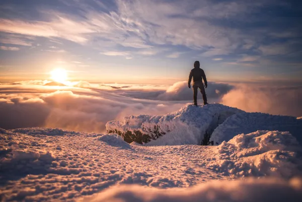A hiker at a winter summit.