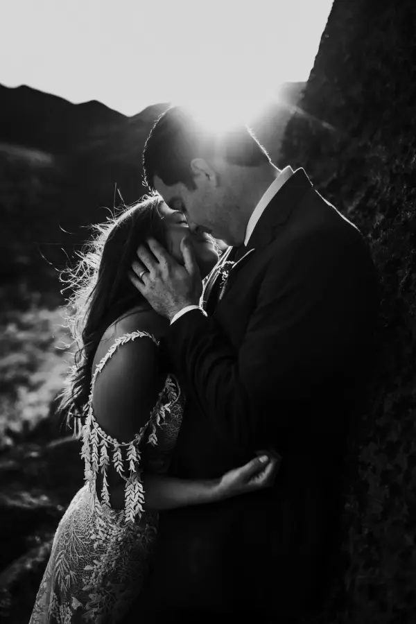 A man and his wife tenderly embrace and lean in to kiss