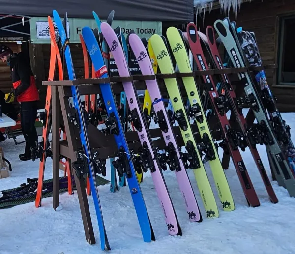 Ski rack filled with different colored skis
