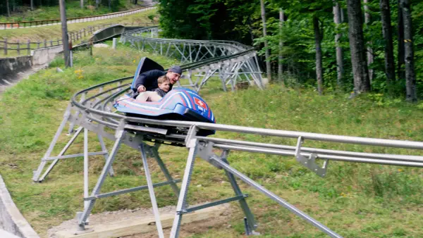 Rider zooms down the cliffside coaster