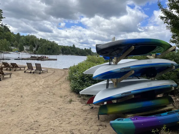 Stack of boats and Paddle Boards on a sandy beach