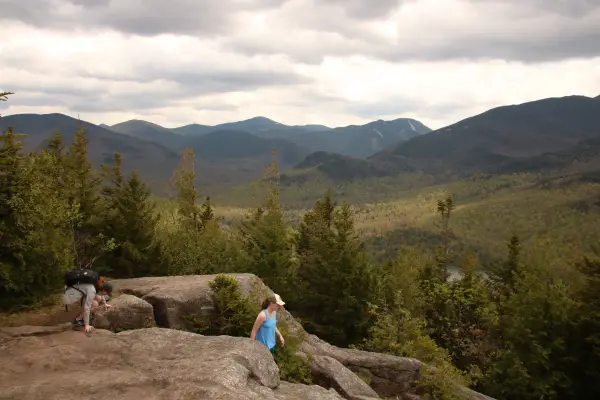 A family hiking a rock summit