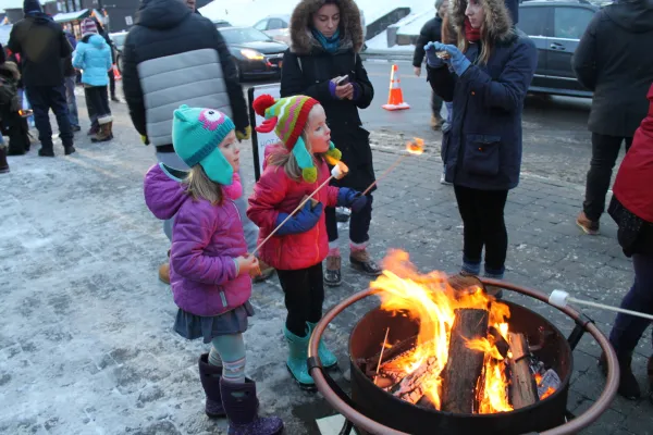 2 children roast marshmallow on Main Street