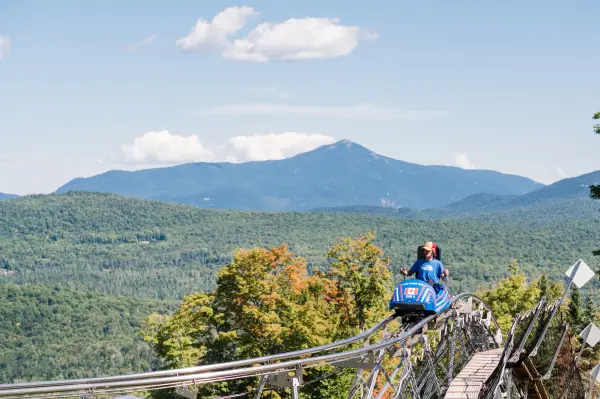 Cliffside coaster with a stunning view of mountains in the backfrouund
