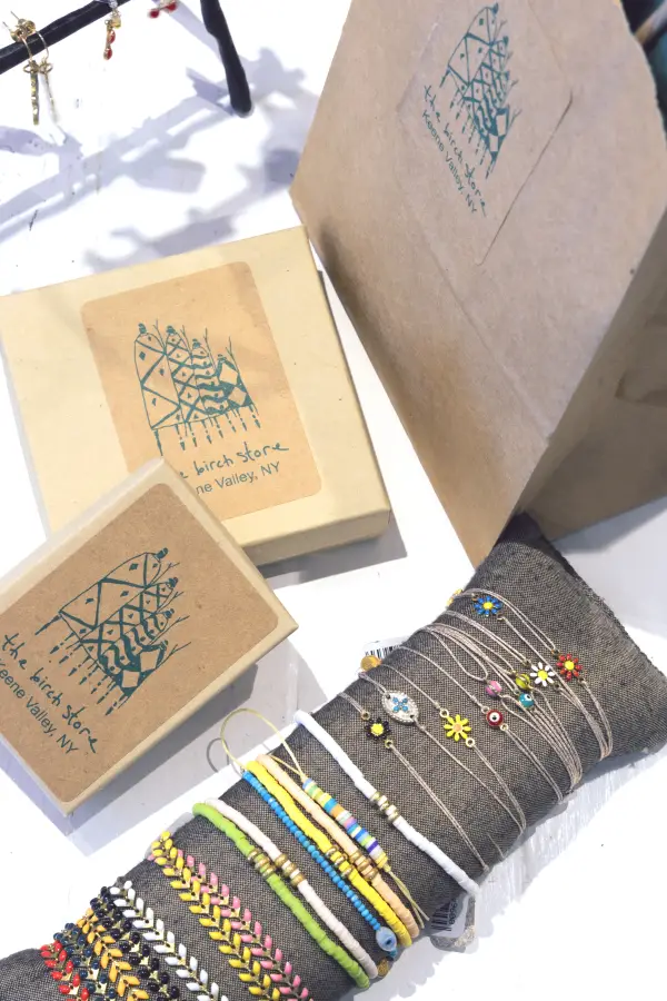 Beaded bracelets in every color next to custom Birch Store boxes