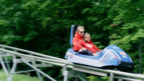 Mother and child ride the Cliffside Coaster