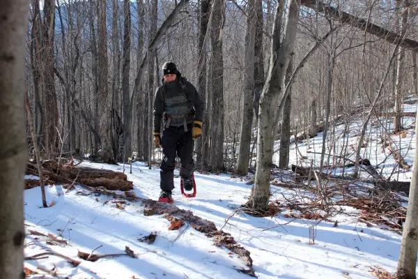 A man shoeshoes along the trail of Bear Den Mountain