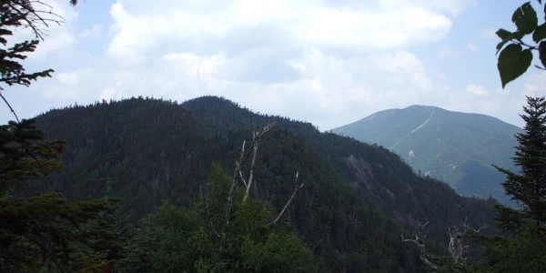 The summit view surrounded by higher mountains.