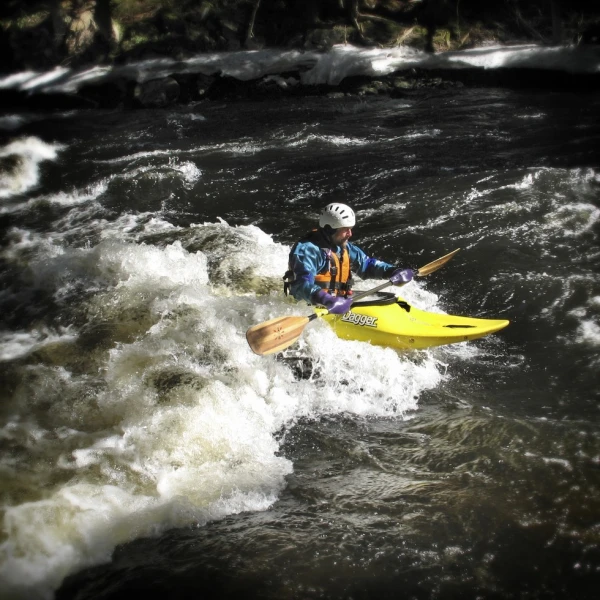 A whitewater kayaker negotiating rapids