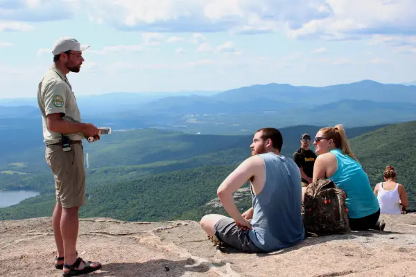 A summit steward educates hikers on the fragile alpine vegetation on Cascade's summit.