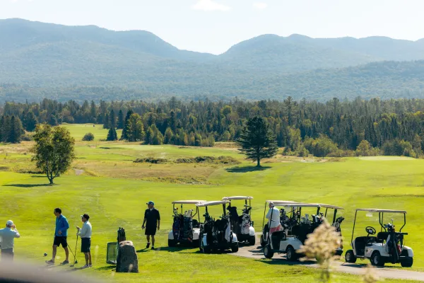 A golf course with mountains in the background. 