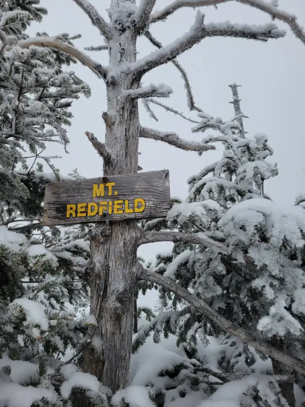 A wooden sign for Mt. Redfield