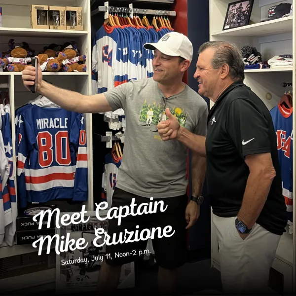 1980 Olympic Gold Medal Men's USA Hockey Team Captain Mike Eruzione poses for selfie in store with fan