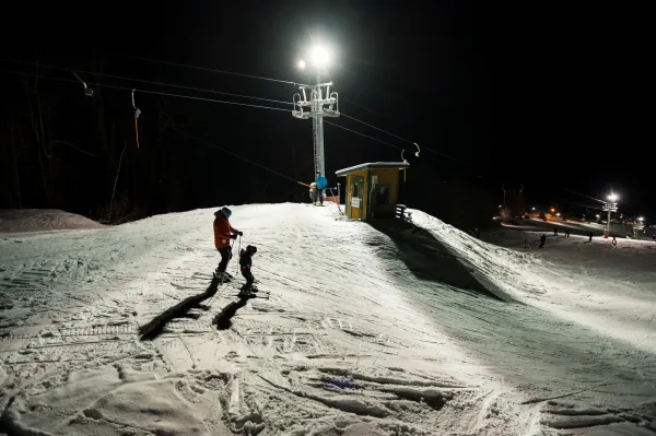A couple skiers on Mt Pisgah at night