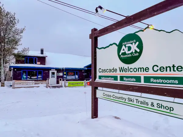 A wooden sign for Cascade Welcome Center