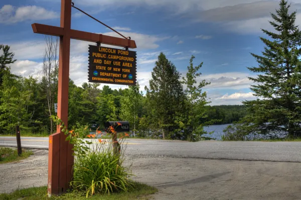 A yellow and brown sign marking a campground.