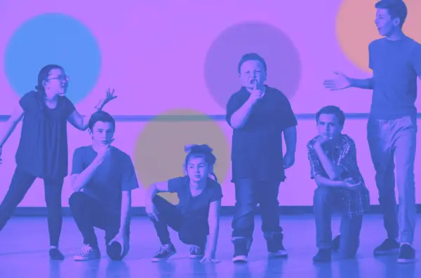 Six children in various poses, appearing to be acting or rehearsing a scene.