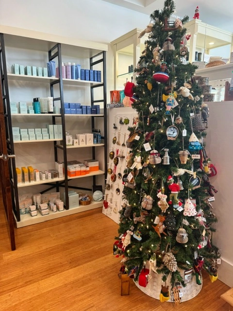 Ornaments and products displayed on a faux tree and tall shelf at The Peaks Boutique at The Mirror Lake Inn.